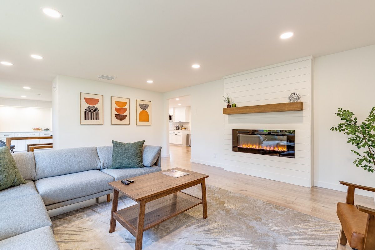 Bright living room with sectional sofa and electric fireplace